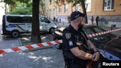 A police officer guards the murder site of former Ukrainian parliamentary speaker Andriy Parubiy in Lviv.