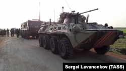 Russian Army military vehicles are seen on a joint patrol with Turkish troops on the western outskirts of the Syrian city of Saraqib in Idlib Province in March 2020.