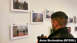 Timur Barotov Emine Ziyatdinovanıñ fotoresim sergisini fotoğa çeke. Lviv, 2016 senesi kiçik ay