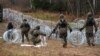 Polish soldiers lay razor wire along Poland's border with the Russian exclave of Kaliningrad in November 2022.