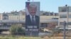 Motorists drive past a billboard depicting US President Donald Trump in Tel Aviv on October 10, 2025.
