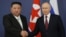 Russian President Vladimir Putin (right) and North Korean leader Kim Jong Un shake hands during their meeting at the Vostochny Cosmodrome in Russia's Amur region on September 13.