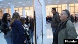 Armenia -- People read vacancy notices at a job fair in Yerevan, November 27, 2019.
