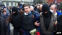 Pro-Russia militants detain the head of the regional police after storming the a police building in the eastern Ukrainian city of Horlivka, near Donetsk.