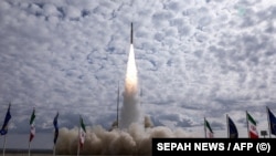 This handout photo provided by Iran's Revolutionary Guards Corps (IRGC) shows the launch of the Qaem-100 satellite launch vehicle. 