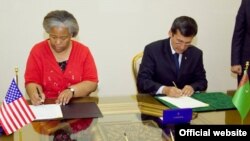 Türkmenistanyň daşary işler ministri Reşit Meredow (sagda) we ABŞ-nyň Türkmenistandaky işleri wagtlaýyn ynanylan wekili Silwia Rid Kurran täze dokumente gol çekişýär, 7-nji iýun, Aşgabat.