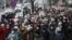 People, including pensioners, parade through the streets during a rally to protest against police violence in Minsk on November 30.
