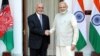 Afghan President Ashraf Ghani and Indian Prime Minister Narendra Modi shake hands on February 9 after signing an agreement to build the Shah Toot on the Kabul River.