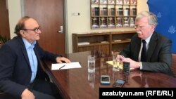 Armenia - U.S. national-security adviser John Bolton (right) speaks with RFE/RL's Harry Tamrazian in Yerevan on October 25.