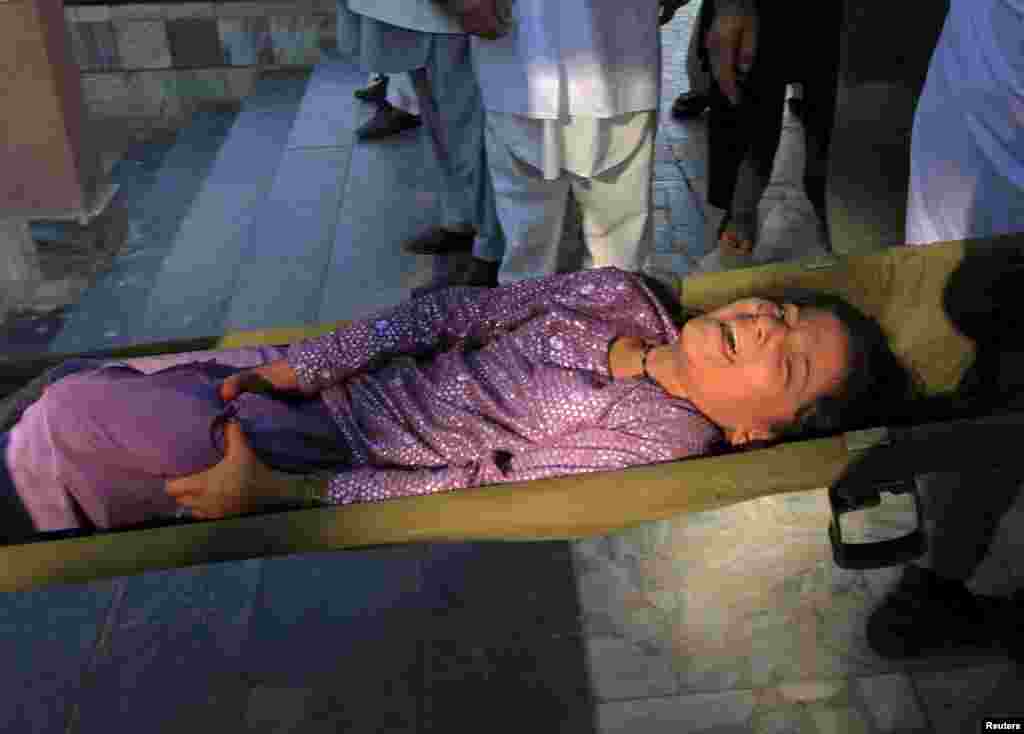 A young girl who was injured in the earthquake awaits treatment in Jalalabad, Afghanistan.