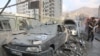People gather near damaged vehicles in the aftermath of Israeli strikes, in Tehran, Iran, June 13, 2025