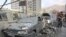People gather near damaged vehicles in the aftermath of Israeli strikes, in Tehran, Iran, June 13, 2025