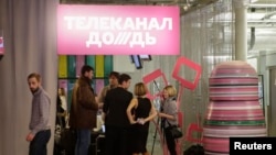 Журналисты телеканала "Дождь" выходят из здания после конференции. Москва, февраль 2014 года.