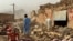 People search the debris of damaged buildings in the aftermath of an earthquake in Samangan Province, Afghanistan, on November 3. 