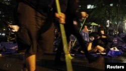Occupy Wall Street protesters clean Zuccotti Park ahead of an eviction notice issued by New York City authorities.