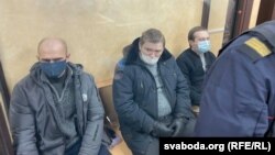 Uladzimer Kniha (left), Yauhen Raznichenka (center), and Dzmitry Furmanau appear in court in Hrodna on January 18.