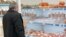 Armenia -- A man looks at meat products at a food store in Yerevan.