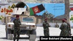 Afghan National Army soldiers keep watch at the site of a suicide attack in Kabul last month.