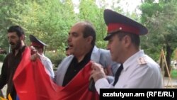 Заместитель начальника Центрального отдела полиции ведет Левона Барсегяна к полицейской машине, 21 сентября 2011 г.  