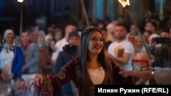 Фатима танцува на площада в селото, огряна от факли и заобиколена от момичета.