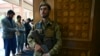 A member of the Afghan security forces stands guard at the Abdul Rahman Mosque in Kabul as people offer prayers for Eid al-Fitr on May 13.