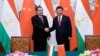 Chinese President Xi Jinping (right) shakes hands with Tajik President Emomali Rahmon in Beijing in September 2015.