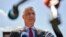 Kosovar President Hashim Thaci speaks to the media as he arrives at the Kosovo Specialist Chambers in The Hague on July 13. 