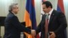 Armenia - President Serzh Sarkisian (L) and Prosperous Armenia Party leader Gagik Tsarukian shake hands during an award ceremony at the National Olympic Committee, Yerevan,26Dec,2012.
