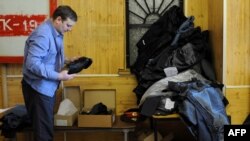 Russia -- A police officer gets a fresh set of his uniform at a store in Moscow, 24Feb2011