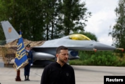 Президент Володимир Зеленський промовляє в День Повітряних сил на тлі винищувача F-16. Серпень 2024 року