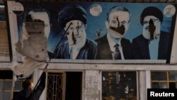 تخریب تصاویر بشار اسد، حافظ اسد، حسن نصرالله و علی خامنه‌ای در یک پمپ‌بنزین در شهرک شیعه‌نشین در حلب، سوریه، ۱۱ دسامبر ۲۰۲۴