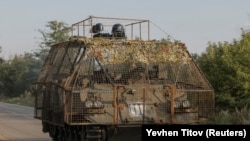 Ukrainian forces ride in an armored personnel carrier near the frontline town of Kostyantynivka.