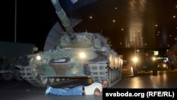 Мужчина лежит перед танком мятежников в Стамбуле.