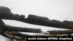 Өрттөлгөн үйлөрдүн бири