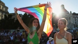 A marcher holds up a flag at the Budapest Pride event.