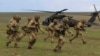 British soldiers disembark from a US military helicopter during the Wind Spring 15 NATO military exercises in Romania on April 21.