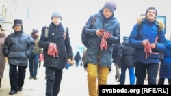 Activists distribute the red-and-white ribbons in Minsk on December 6.