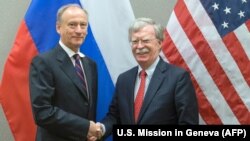 John Bolton (right), the U.S. national security adviser, shakes hands with his Russian counterpart, Nikolai Patrushev, during a meeting in Geneva on August 23.