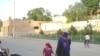 A woman and child on a Chorkuh street