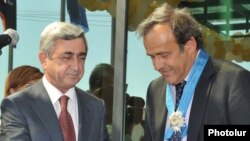 Armenia -- President Serzh Sarkisian gives a Medal of Honor to UEFA President Michel Platini, 1Sept 2010.