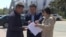Kazakhstan - A representative of the akimat of Astana (center) passes a written refusal to those who applied for the May 21 rally "on the land issue". Astana, 18May2018.