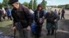 Residents from Vovchansk and nearby villages in the Kharkiv region wait for buses amid an evacuation to Kharkiv due to Russian shelling on May 10.