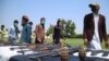 Former Taliban and other militants surrender their weapons during a reconciliation ceremony in Jalalabad on June 25.