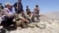 Members of the National Resistance Front observe from a hill in the Panjshir Valley.