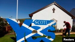 A "Yes" campaign supporter is seen near the town of Portree on the Isle of Skye (Scotland referendum)