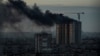 Smoke rises over a residential building after a Russian missile and drone strike in Kyiv on December 29.