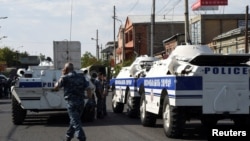 Policemen block a street after a group of armed men seized a police station in Yerevan, July 17, 2016.