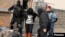 Armenia - Security forces detain a woman in a raid on a house in Yerevan's Nork district, 25Nov2015.