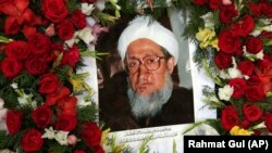 A portrait of former Afghan President Sibghatullah Mojaddedi is seen during his funeral procession at the presidential palace in Kabul on February 13.