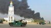 Afghan security forces arrive after a powerful explosion outside the provincial police headquarters in Kandahar on July 18.